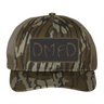 Brown camouflage cap with a black and brown 'DMFD' logo patch on the front.