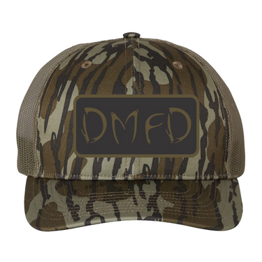 Brown camouflage cap with a black and brown 'DMFD' logo patch on the front.